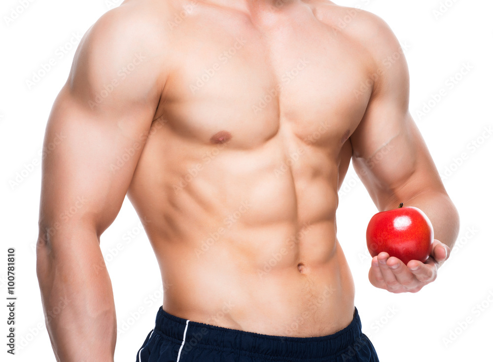 Young man with perfect body holding red apple. Young man with perfect body holding red apple.