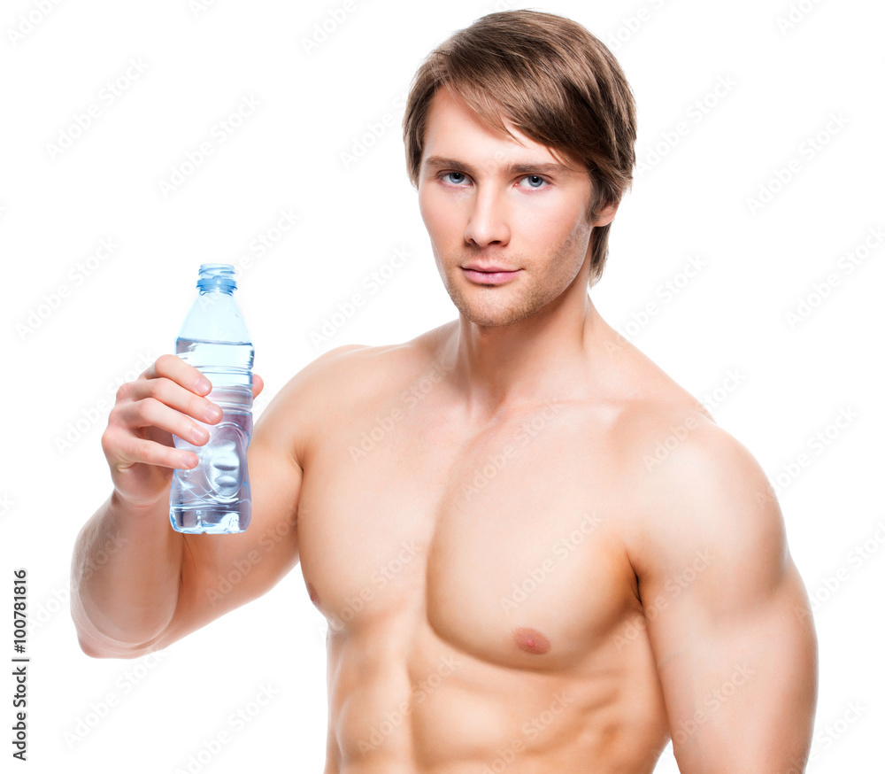 Muscular shirtless sportsman holds water. Muscular shirtless sportsman holds water.