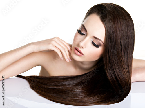 Portrait of beautiful young woman with long straight brown hair