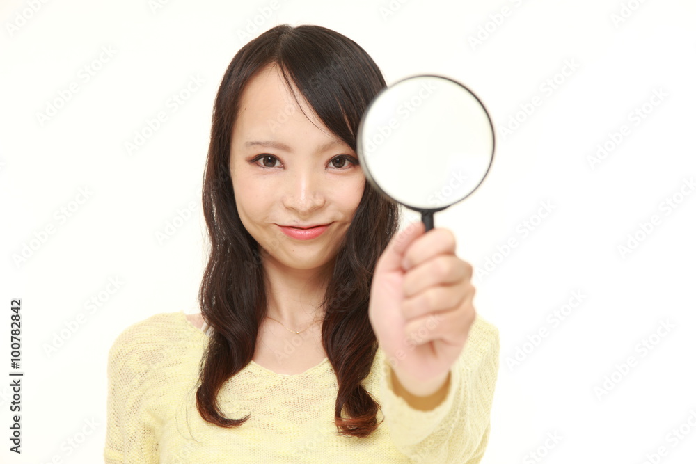 Japanese woman with a magnifying glass Japanese woman with a magnifying glass