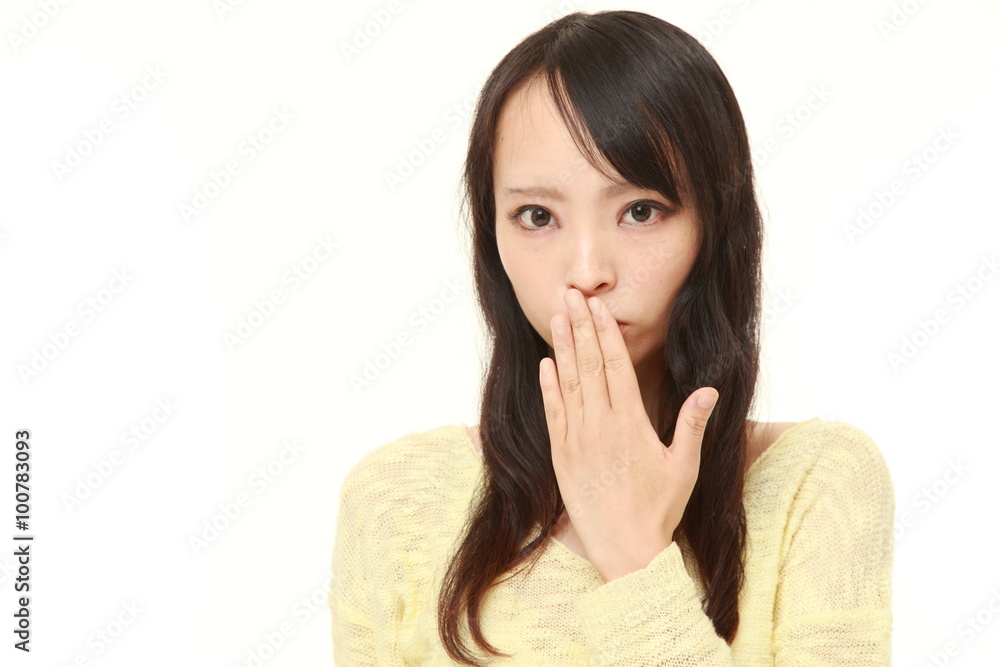 Japanese woman making the speak no evil gesture Japanese woman making the speak no evil gesture