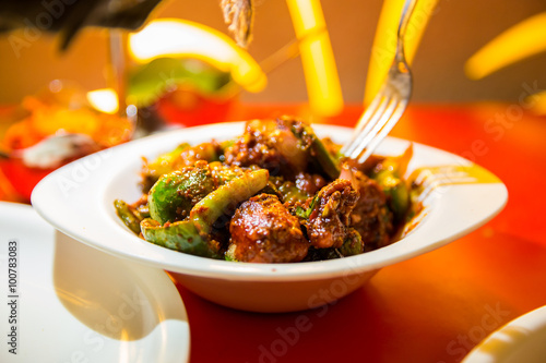 hot and spicy chicken chilli in a serving bowl in a restaurent s photo