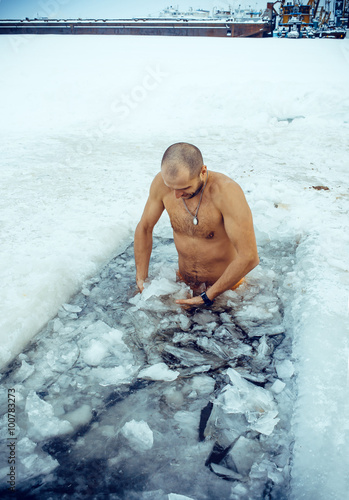 A man swims in the winter