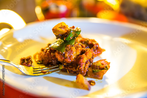 hot and spicy chicken chilli in a serving bowl in a restaurent s photo