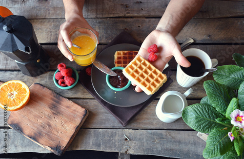 overhead photograph of person with breakfast waffles with marmal photo