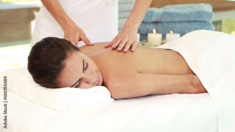 Masseuse giving massage to relax woman Masseuse giving massage to relax woman