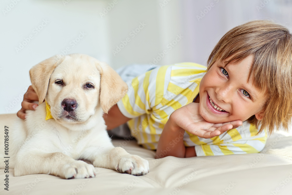 Happy kid with a dog at home Happy kid with a dog at home