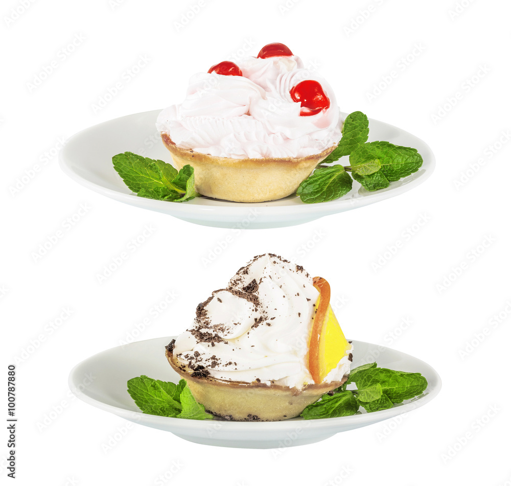 Set of cream cake with cherry and orange, chocolate on a white saucer, isolated on the white Set of cream cake with cherry and orange, chocolate on a white saucer, isolated on the white