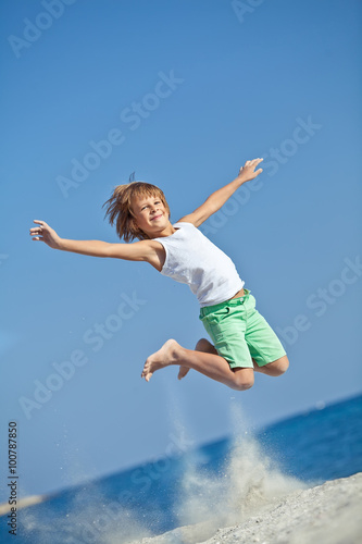 kid are jumping on the beach 