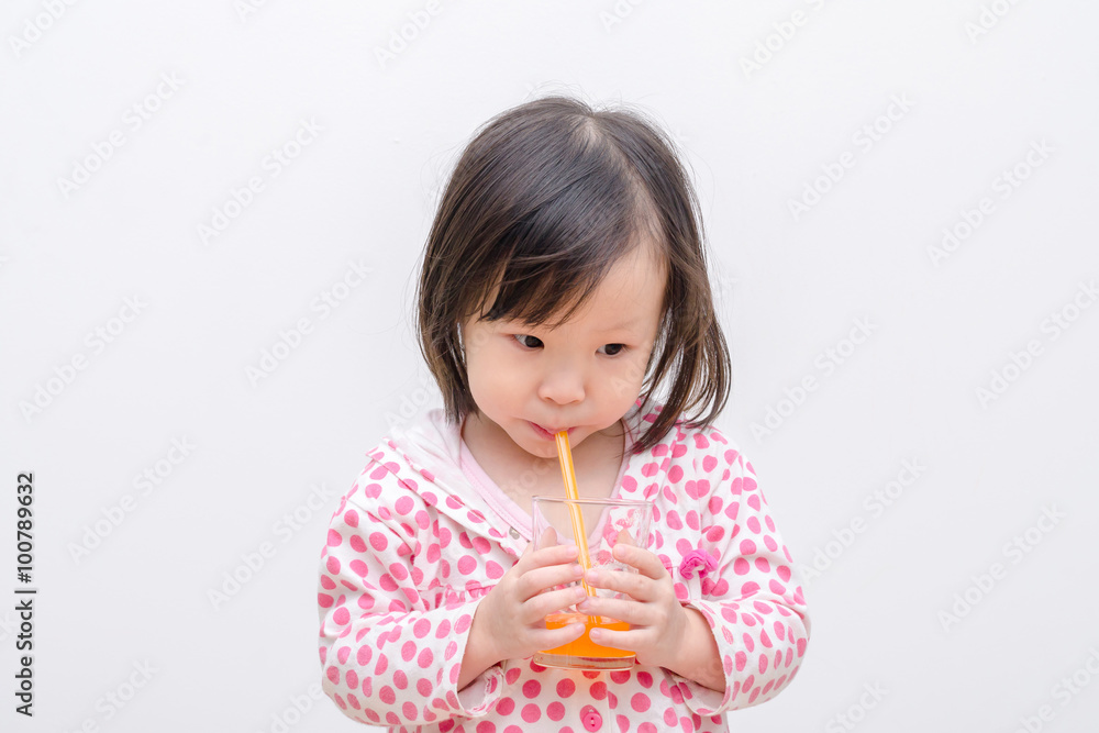 Little Asian girl drinking orange juice Little Asian girl drinking orange juice