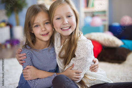 Portrait of charming blonde sisters. photo