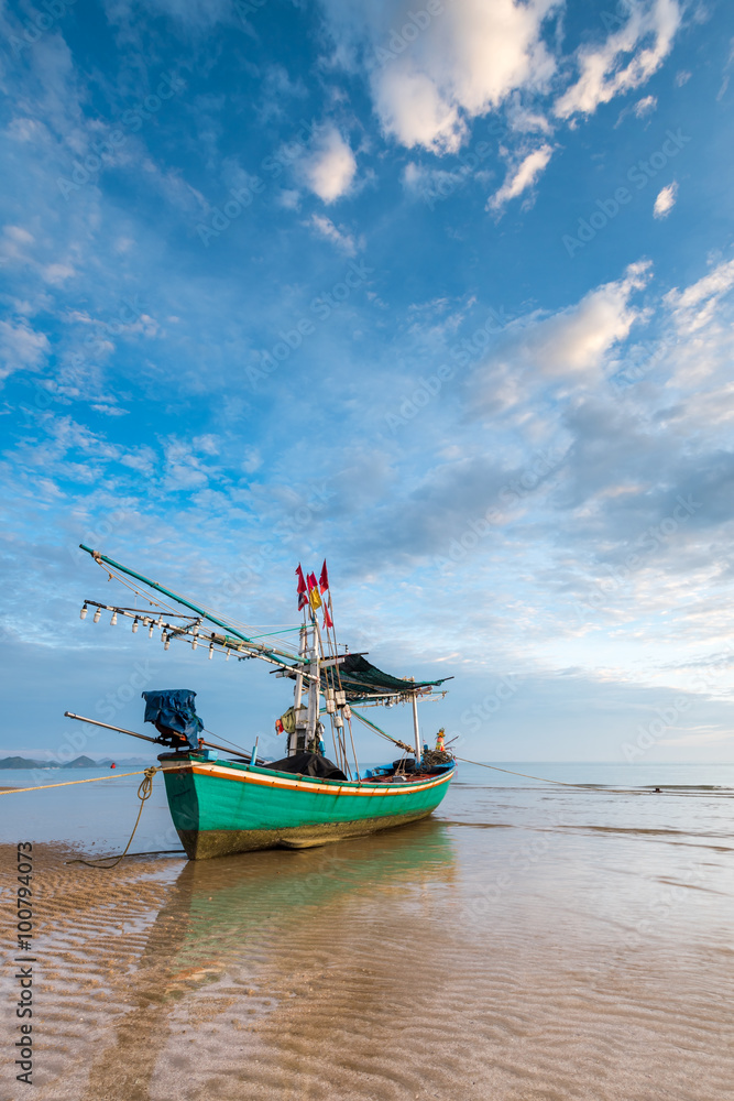 Fototapeta premium Samroiyod Beach, fishing boat parked on beach, background is blue sky
