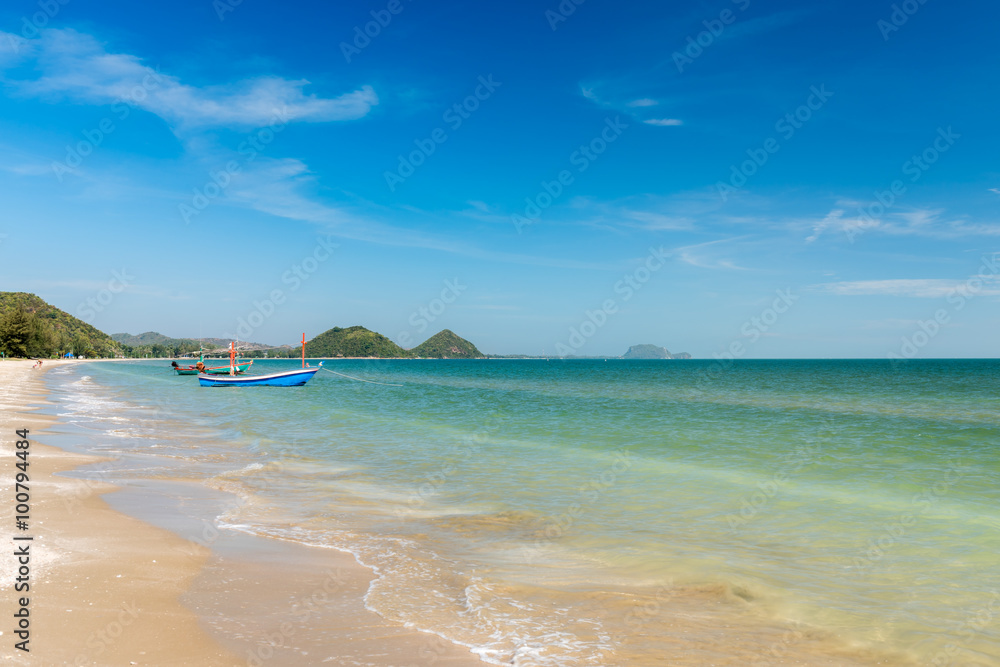 Samroiyod Beach, fishing boat parked on beach, background is blue sky