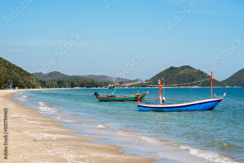 Samroiyod Beach, fishing boat parked on beach, background is blue sky © dewspliff