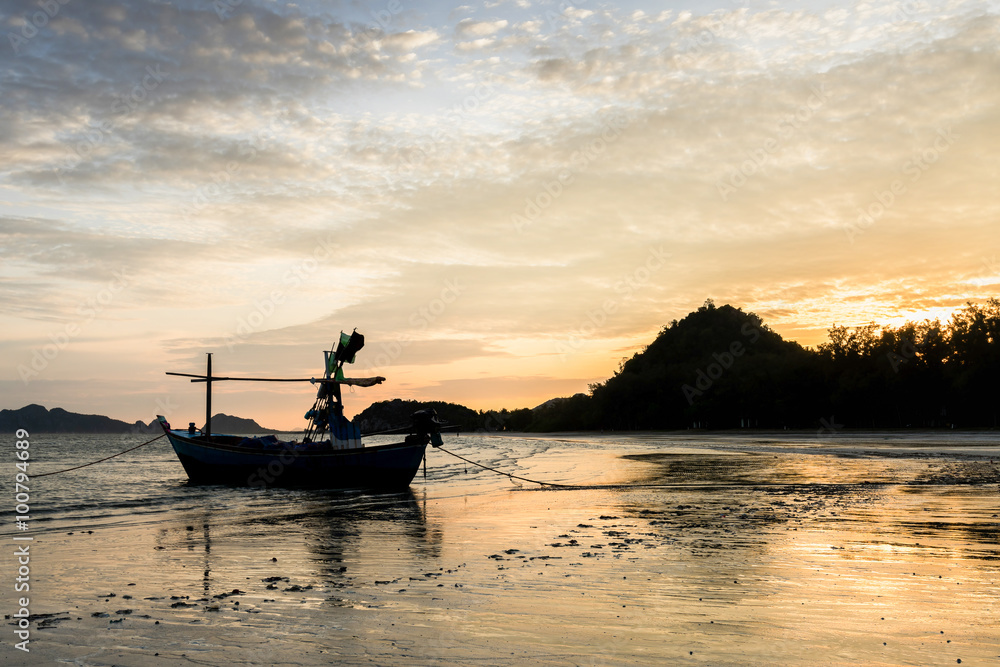 Samroiyod Beach, Thailand, fishing boat parked on the beach,  background is twilight sky at sunrise time with reflection sky