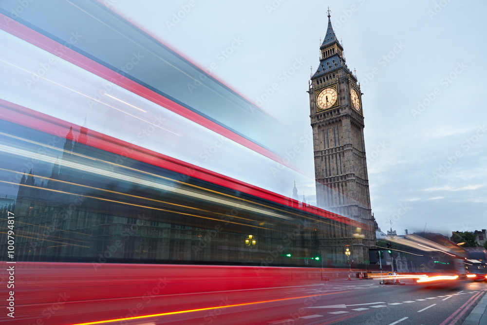 Big Ben in the early morning and red bus passing in London