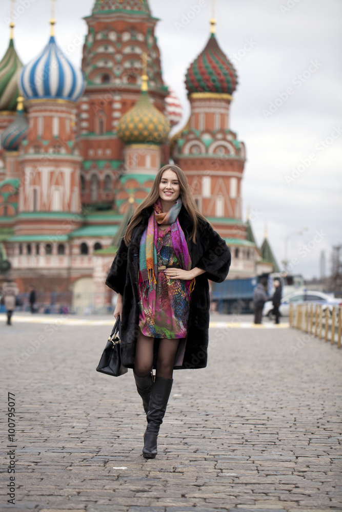 Young woman in a mink coat on the Red Square in Moscow