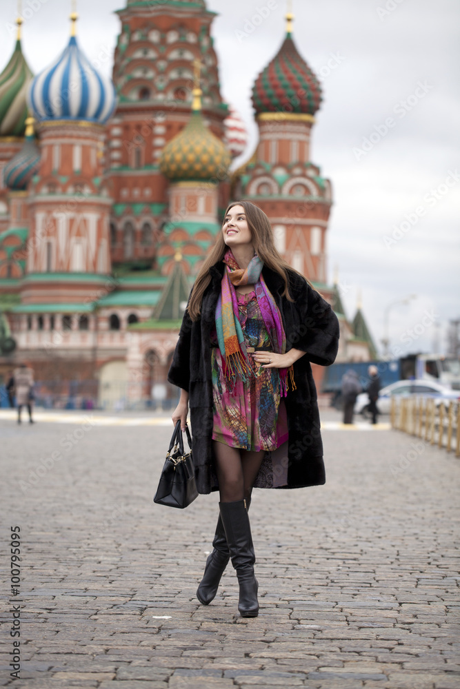 Young woman in a mink coat on the Red Square in Moscow