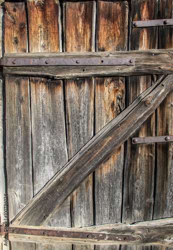 Old wooden weathered door of barn