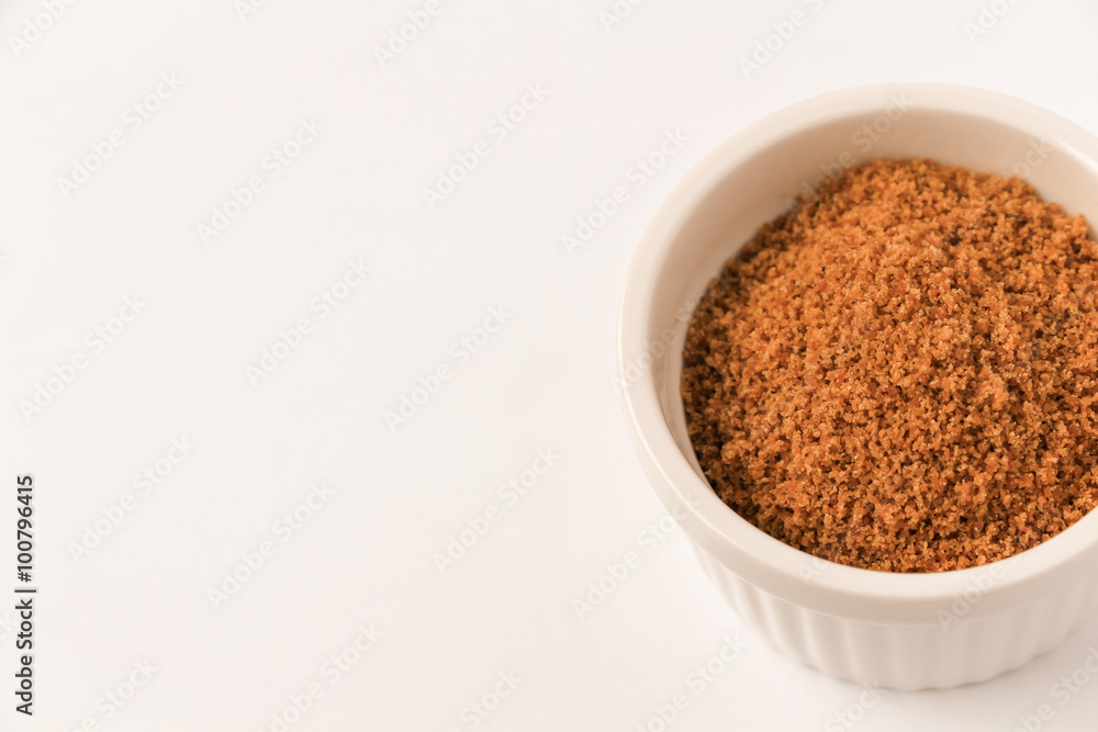 Coconut sugar in a cup with white background Coconut sugar in a cup with white background