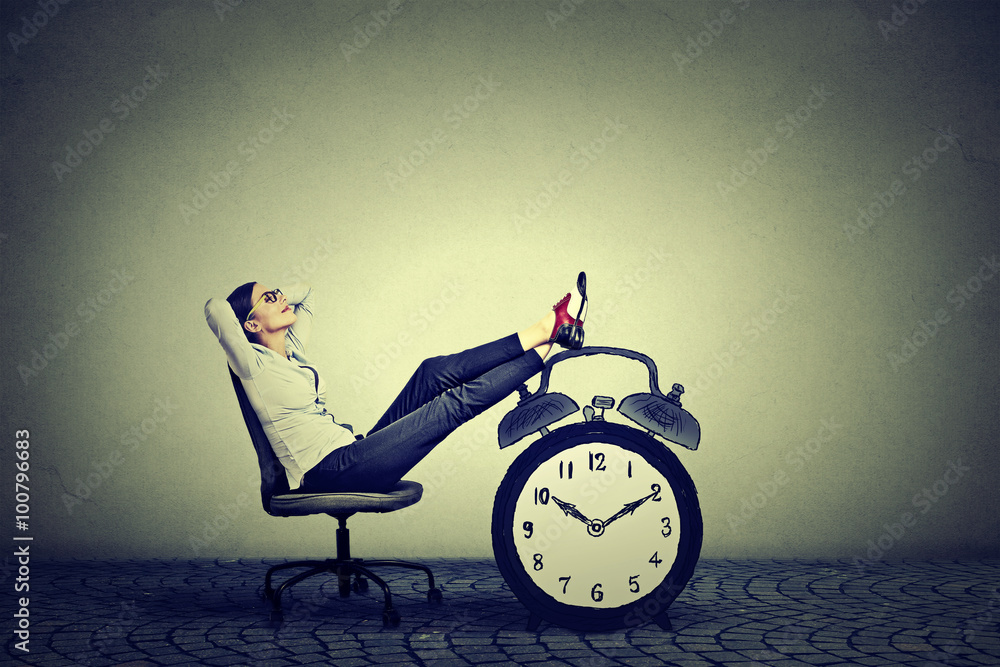 Business woman relaxing sitting in office. Stress free time management concept - obrazy, fototapety, plakaty 