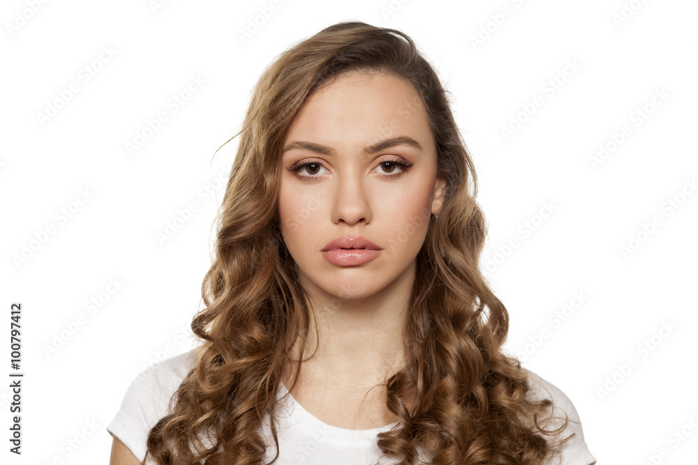 serious beautiful girl on a white background serious beautiful girl on a white background