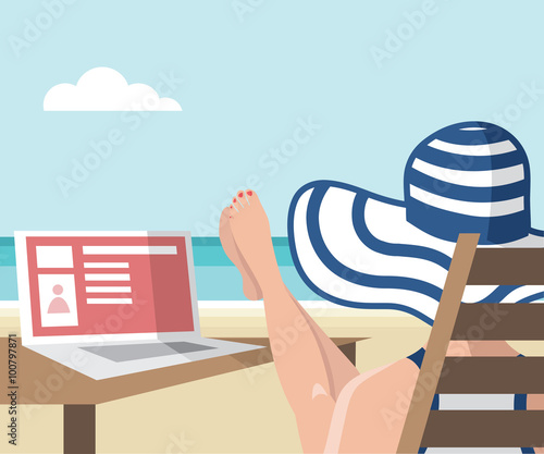 Girl sitting on the beach with her laptop