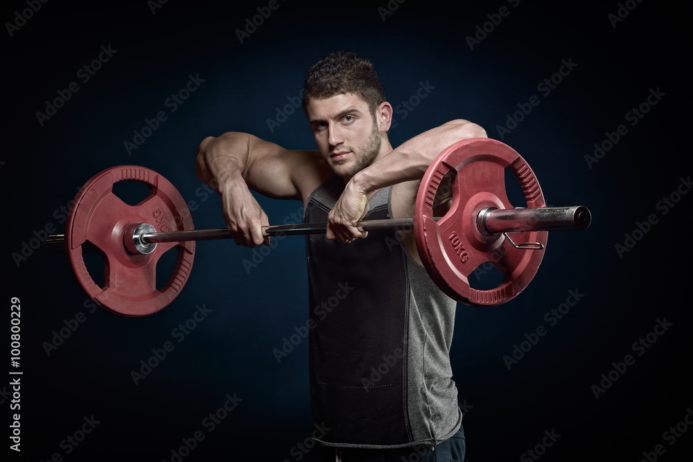 athletic young man lifting weights athletic young man lifting weights