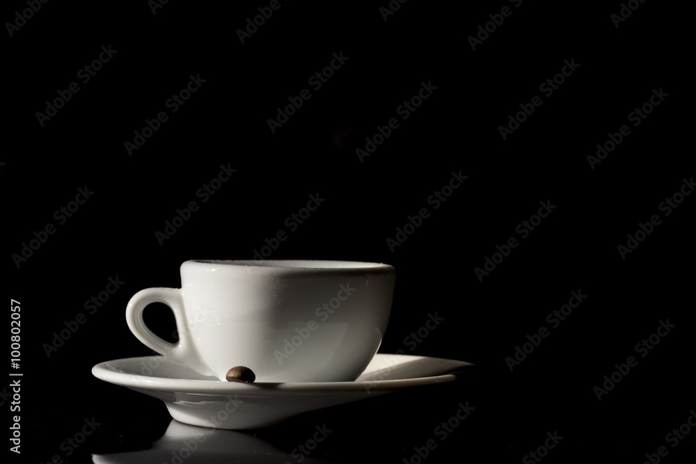small white cup of Italian coffee on black background small white cup of Italian coffee on black background