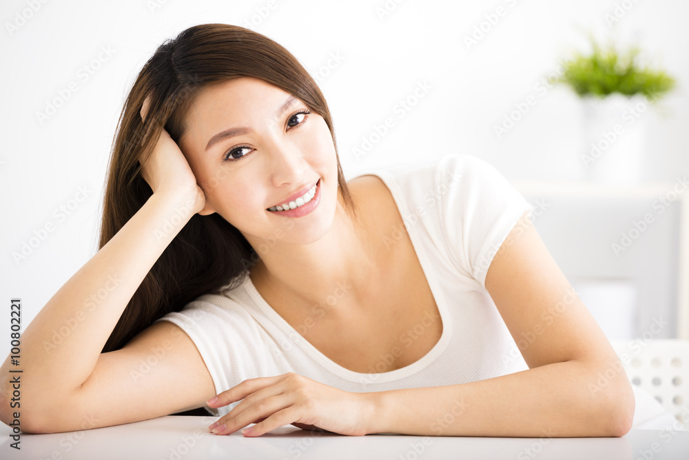 relaxed young smiling woman in living room relaxed young smiling woman in living room