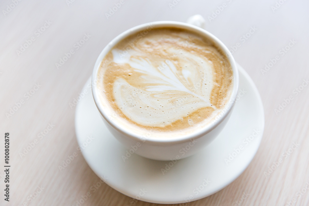 Hot art Latte Coffee in a cup on wooden table Hot art Latte Coffee in a cup on wooden table
