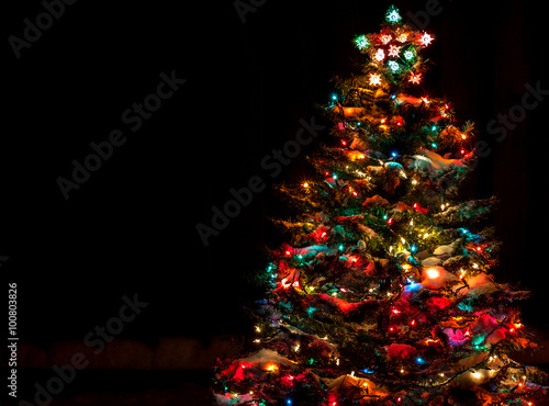 Snow Covered Christmas Tree with Multi Colored Lights