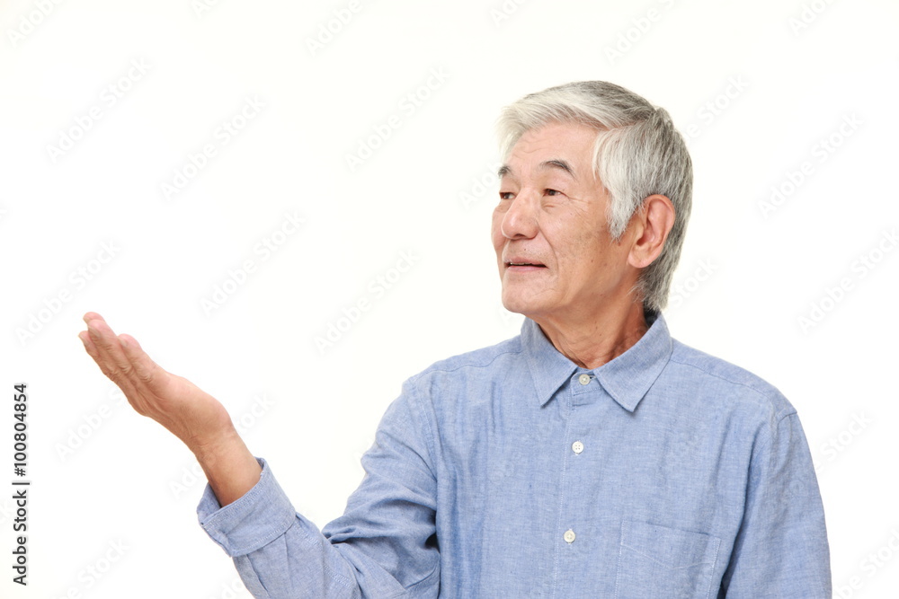 senior Japanese man presenting and showing something senior Japanese man presenting and showing something