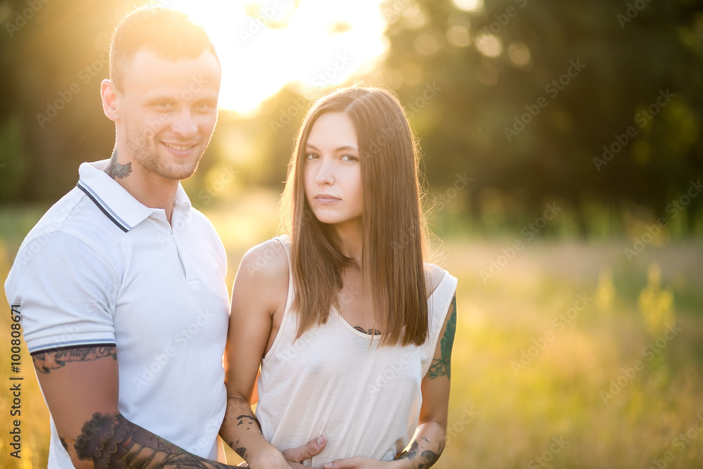Naklejka premium Beautiful young loving couple hugging in nature. The concept of good mood