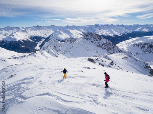 DAVOS, SWITZERLAND - JANUARY 12, A couple of skiers skiing downhil course in the Parsenn mountains, Davos, Switzerland, 2015
