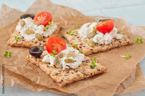 Canape made cookies with cheese, cherry tomatoes and black olive