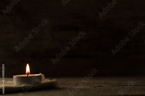  light burning brightly candles on old wooden background. Spa, meditation, ritual, flavored.