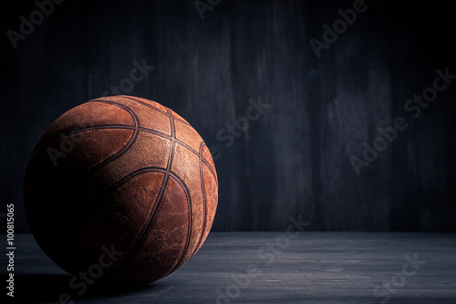 Old basketball ball on a black background