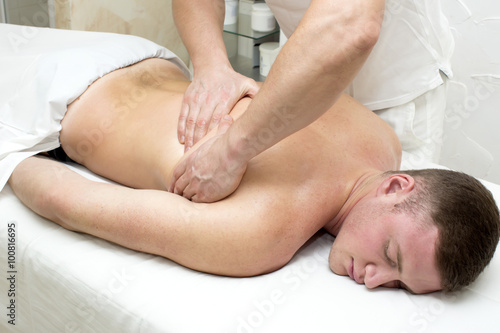 man doing sports massage at the massage parlor