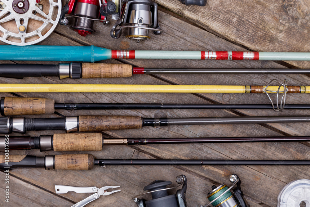 fishing rods and reels on wooden boards fishing rods and reels on wooden boards