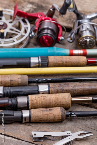 fishing rods and reels on wooden boards