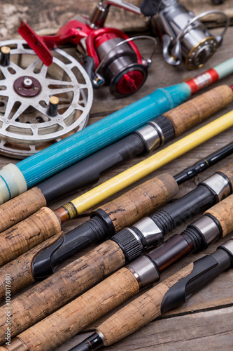 fishing rods and reels on wooden boards