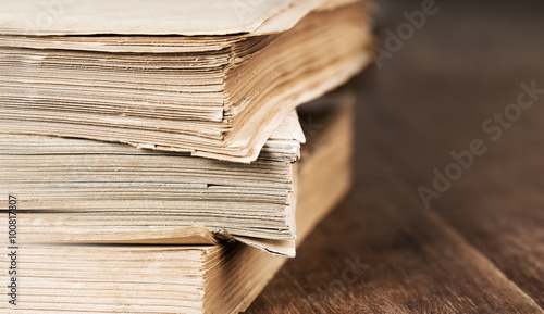 stack of old books isolated on wooden table