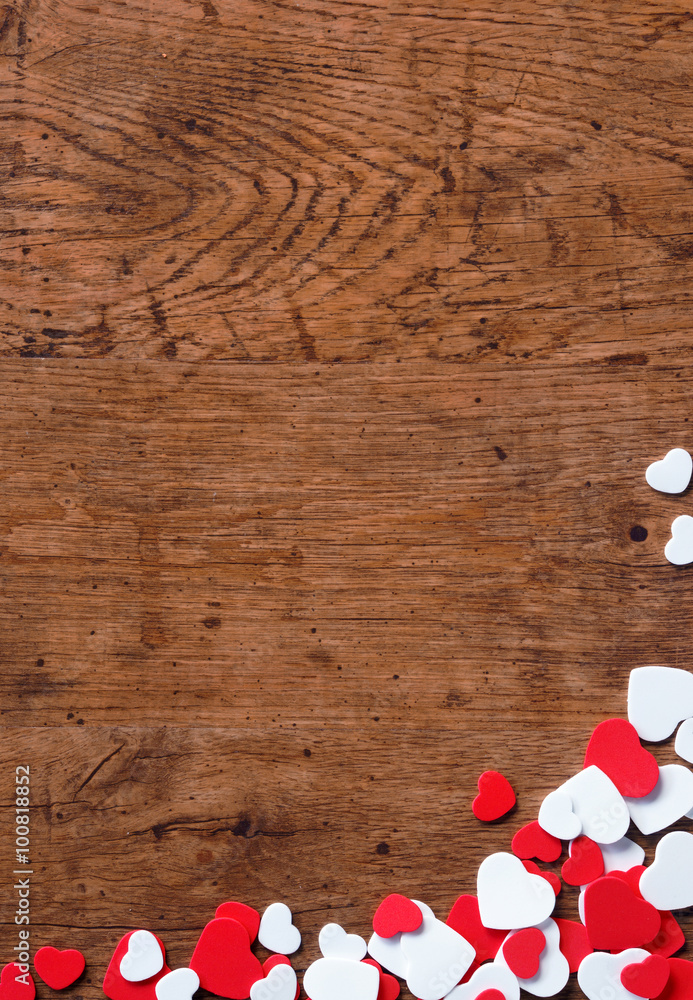 Valentines Day background with heap of small hearts on wooden background. Copy space for your text Valentines Day background with heap of small hearts on wooden background. Copy space for your text
