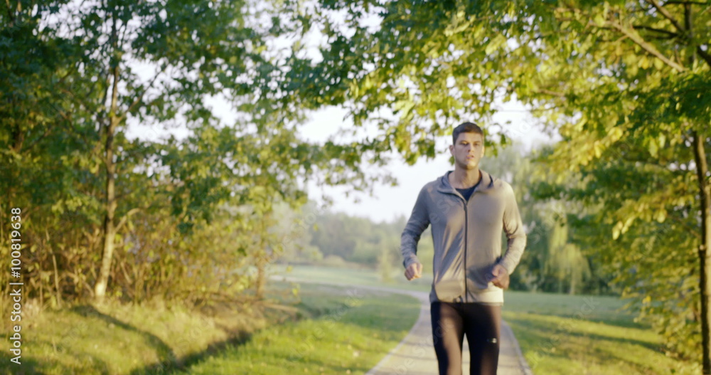 Young man running at morning in park