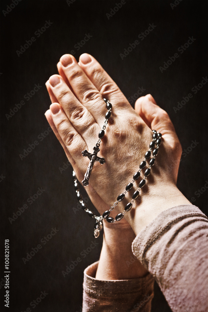  Caucasian person's hands tighten a Christian rosary for prayer. concept of religious belief and faith. - obrazy, fototapety, plakaty 