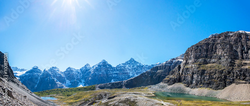 two hikers on a small trail in the Valley of the Ten Peaks in the national park of banff in the rocky mountains of alberta canada