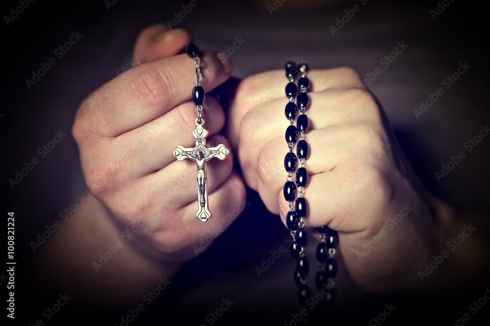 Caucasian hands tighten Christian rosary for prayer. religious belief faith. Caucasian hands tighten Christian rosary for prayer. religious belief faith.