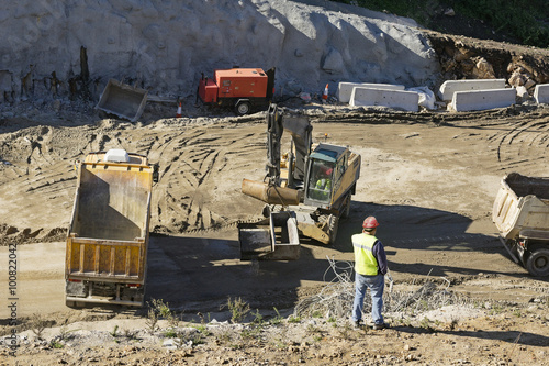 engineer foreman in highway construction site with excavators selective focus 