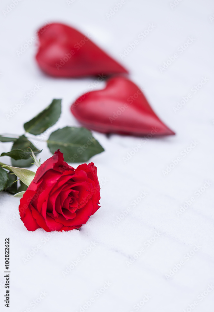 Eine rote Rose und zwei rote Herzen im Schnee, vertikal Stock-Foto | Adobe  Stock